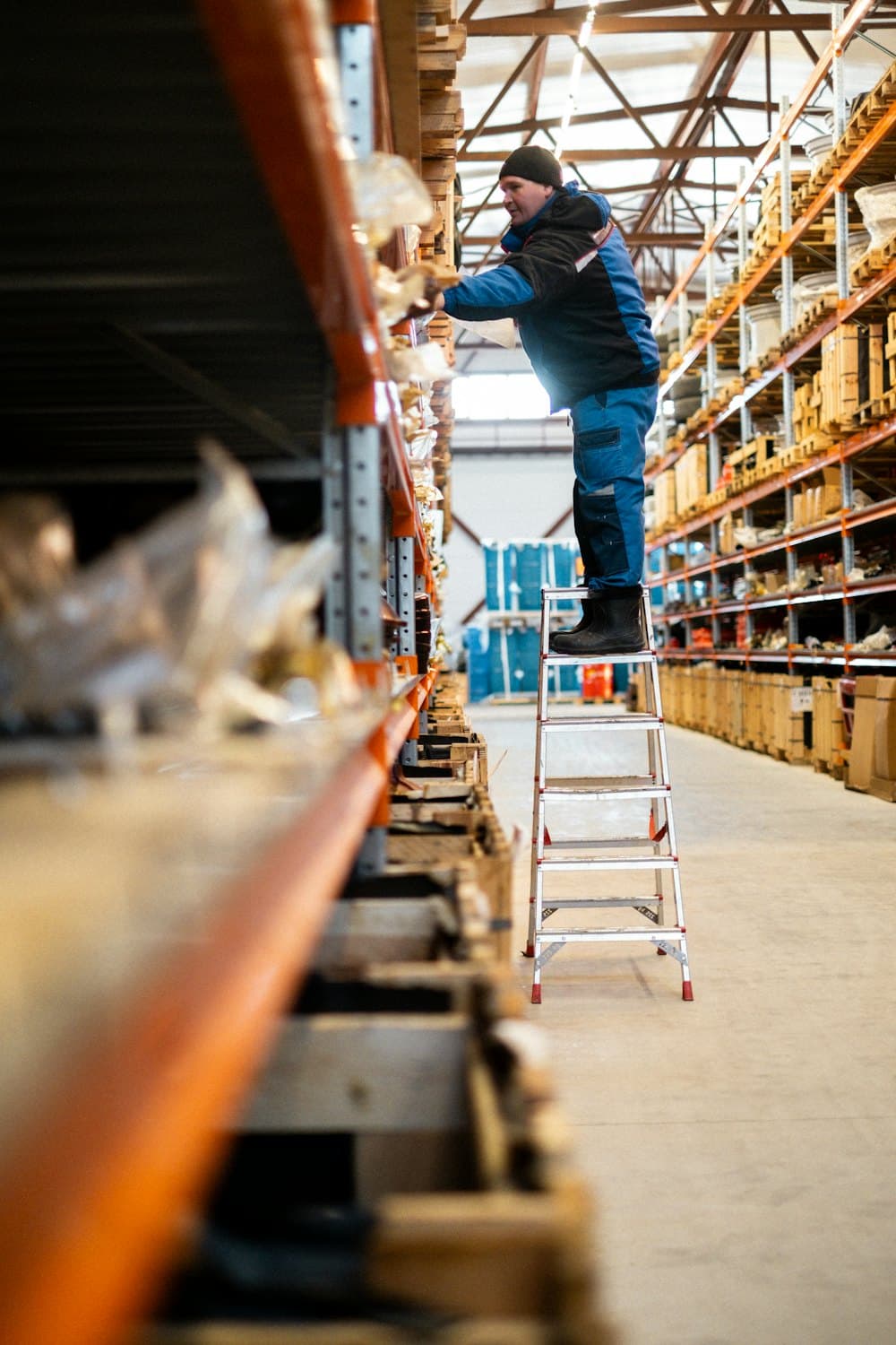 A parts seller picking stock from warehouse racking